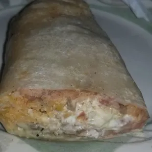 a close up of a burrito on a plate