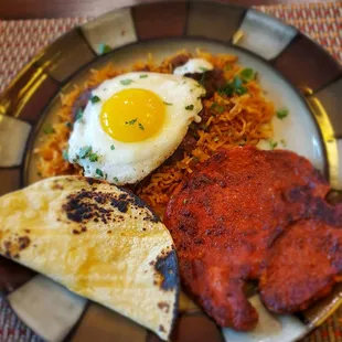Fried marinated pork chop (with my rice and beans and a fried egg on top). Seriously obsessed with these!