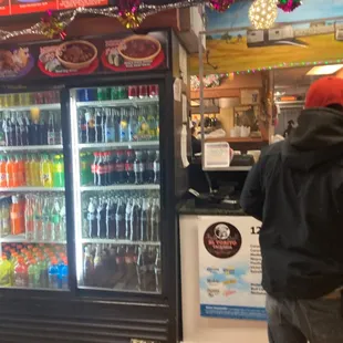 a man standing in front of a refrigerator