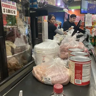 a woman preparing food in a store