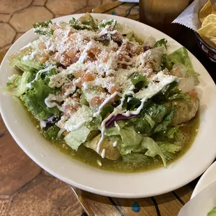 Carnitas enchilada with green sauce