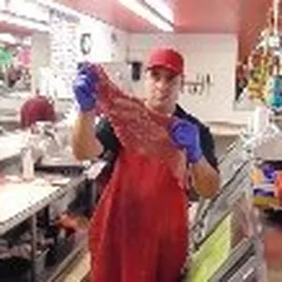 a woman holding a piece of meat