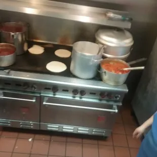 a woman cooking in a kitchen