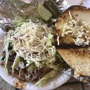 Carnitas torta with everything, lime &amp; jalapeños on the side