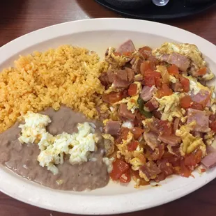 Eggs with ham tomatoes jalapeño, rice, beans and option of Mexican toast or tortillas- reminds me of breakfasts growing up