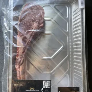 a piece of meat in a plastic container