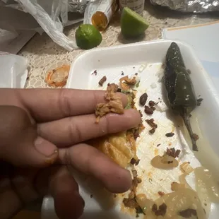 a person's hand holding a piece of food