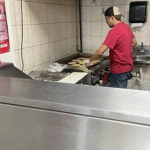 a man preparing food in a commercial kitchen