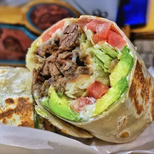 a burrito with meat and vegetables