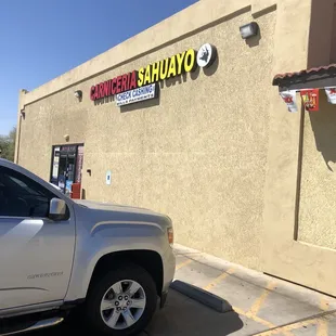 a truck parked in front of a restaurant