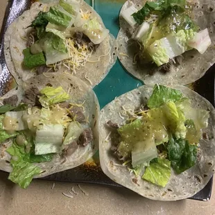 four tortillas on a plate