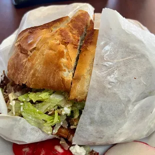 a sandwich wrapped in wax paper