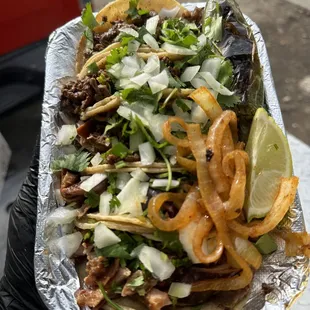 a hand holding a plate of food