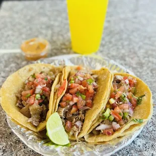 a plate of tacos and a drink