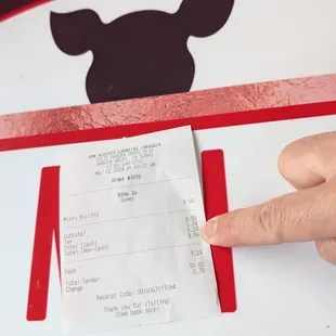 a hand holding a receipt