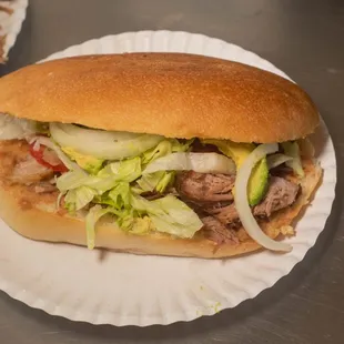 a sandwich on a paper plate