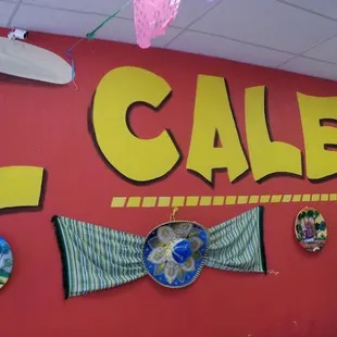 a red wall with a sign that says