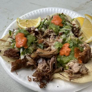 Three tacos - carnitas, surtido, and costilla mixed - all dressed up