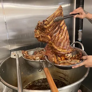 a large pot of meat being cooked