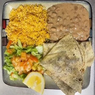 Delicious Asada Quesadilla with beans, rice, and a salad