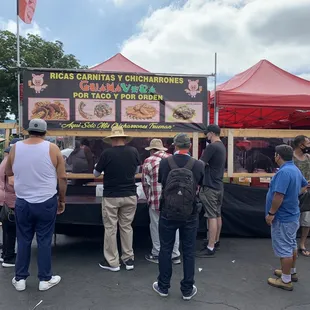a group of people at a food stand