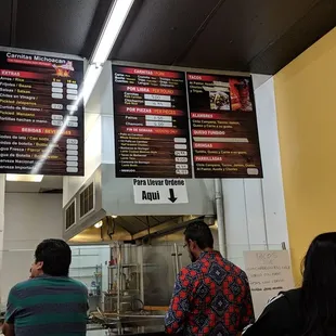 People buying carnitas by the pound to go.