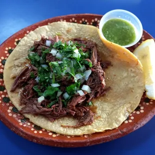 Birria taco, handmade tortilla, killer salsa verde. Gotta love the plate.