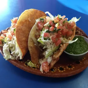 Hard shell potato tacos, home made tortillas. Lots of fresh lettuce, tomato, queso fresco, crema, salsa verde to balance everything out.