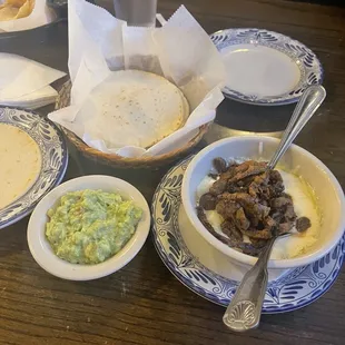 $5 bland Guacamole $12 Queso Fundido