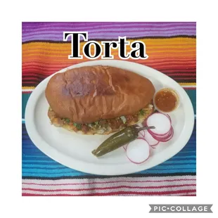 a plate with a sandwich and pickles