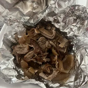 a close up of a piece of meat wrapped in foil