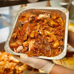 a person holding a tray of food