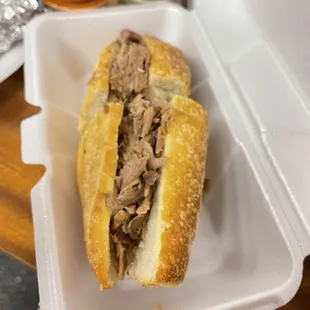 Signature Dish - Torta Ahogada  Oven Baked fresh briote bread filled with Carnitas.  Sauce on the side to pour over.