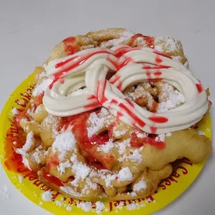 Funnel cake with ice cream and strawberry sauce