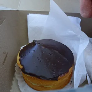 a chocolate frosted donut in a box