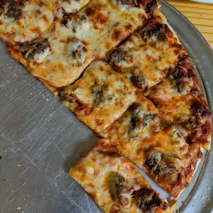 Slightly more than half of a 14&quot; sausage pizza