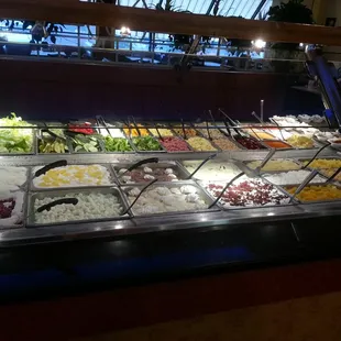 a variety of salads in a buffet