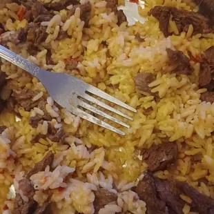 a plate of rice and meat