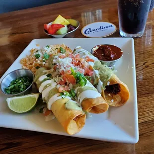 BBQ pork flautas with rice and fresh fruit.