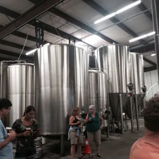 Everyone enjoying free beer in the brewery before the tour