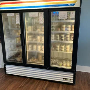 Refrigerator section of GF cupcakes and other items