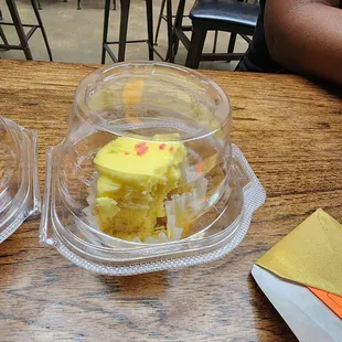 two plastic containers on a wooden table