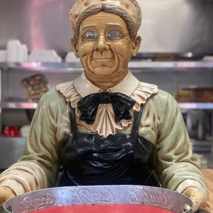 a statue of a woman holding a tray
