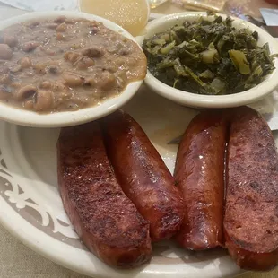 Sausage plate with black eyed peas and turnip greens.