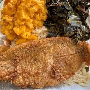 Fried catfish over white rice with collard greens and macaroni and cheese