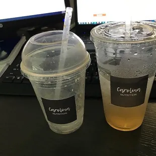 two cups of iced tea next to a computer keyboard