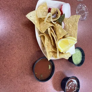 Complimentary chips with a bar for salad and jalapeños etc