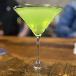 a green drink in a martini glass