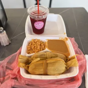 a plate of tamales and a drink