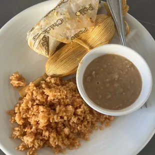 Tamales combo-chicken tamal and a tamal de puerco estilo sinaloa with rice and beans